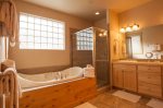 Primary bath with deep soaking tub and separate shower.